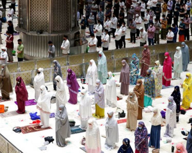 Indonesia Muslims begin Ramadan with social distanced prayers, COVID-19 vaccines