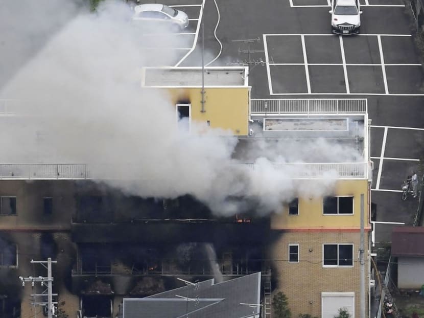 Thick clouds of smoke are seen billowing up from an animation firm building on fire.