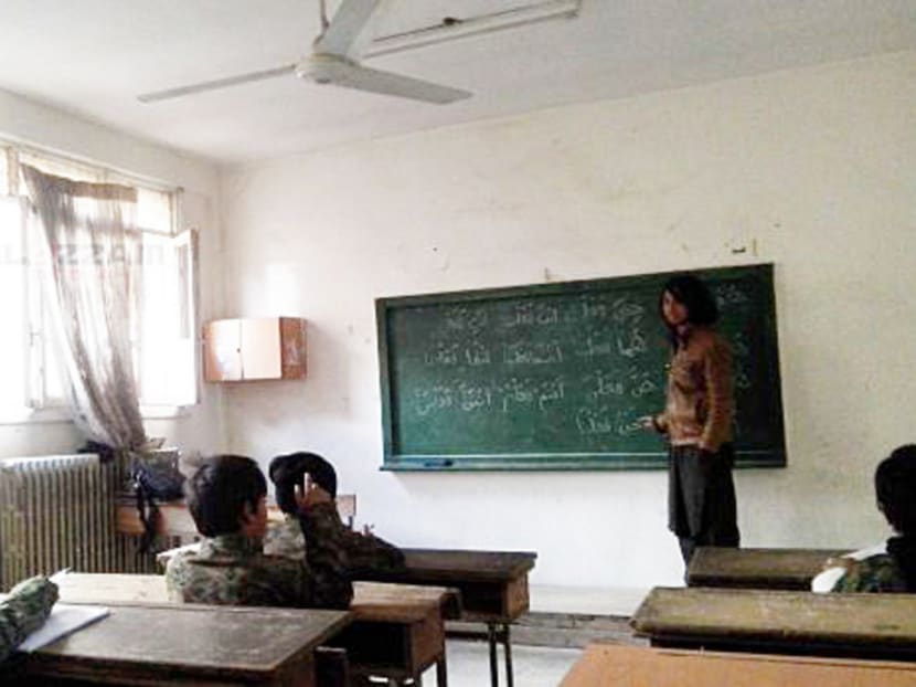 Islamic State child recruits in class. This picture was released by the Abdullah Azzam Academy, which is named after the ideological mentor of Al Qaeda icon Osama bin Laden. Photo: Malay Mail Online