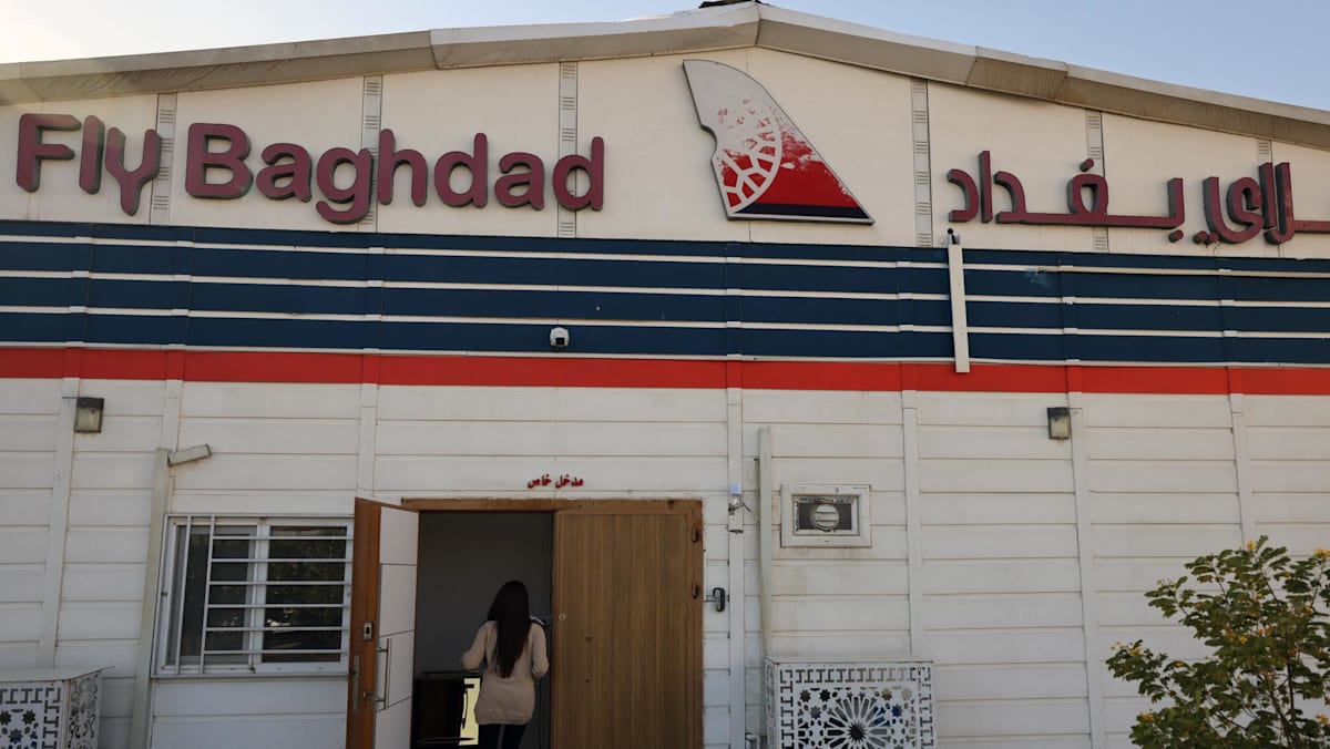An employee enters the headquarters of the Iraqi airline Fly Baghdad at Baghdad's International Airport on Jan 23, 2024. (Photo: AFP/Ahmad Al-Rubaye)