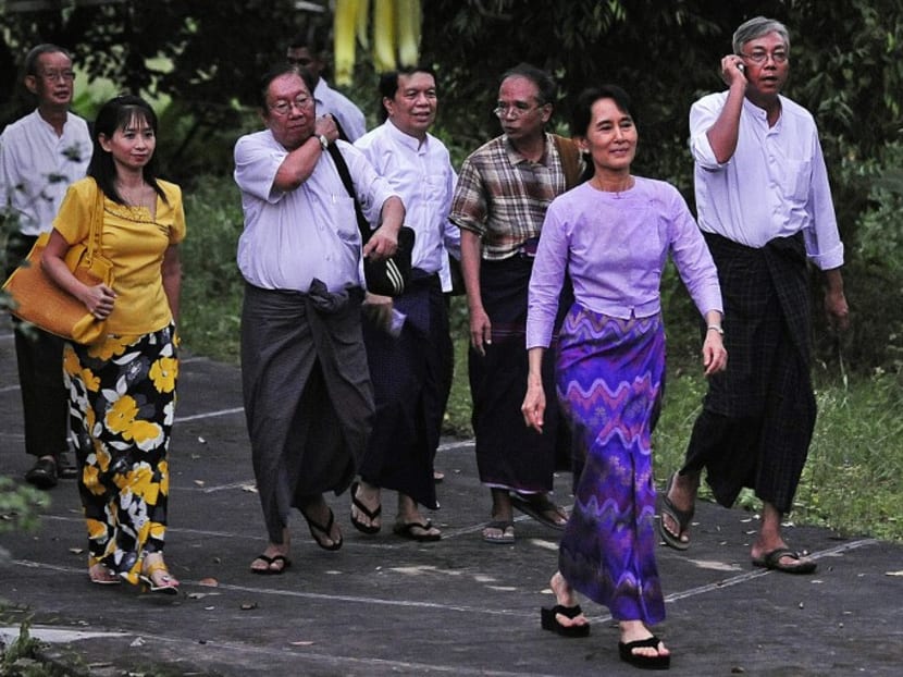 Aung San Suu Kyi (R front) followed by senior National League for Democracy (NLD) staff walks towards the gate of her house to meet with supporters after her release from house arrest in Yangon. The senior staff Nyan Win (3L) NLD spokesman, Tin Myo Win (4L) a physician, Han Tha Myint (5L) senior NLD official and Htin Kyaw (7L) an NLD veteran. Tin Myo Win and Htin Kyaw are viewed by observers as possible nominees for president. Photo: AFP