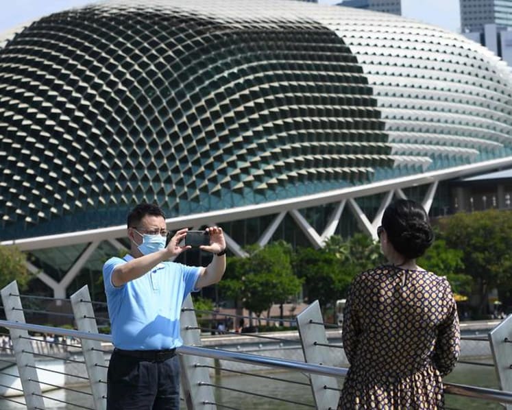 US raises COVID-19 travel alert level for Singapore, Hong Kong
