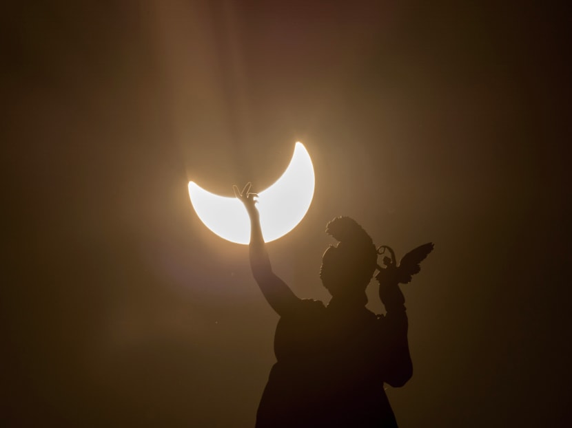 A partial solar eclipse is visible over a statue located at the rooftop of Austrian Art History Museum in Vienna on March 20, 2015. Photo: AFP A partial solar eclipse is visible over a statue located at the rooftop of Austrian Art History Museum in Vienna on March 20, 2015. Photo: AFP