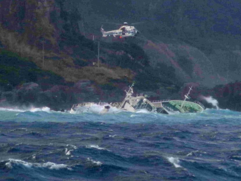 This handout photo taken on March 4, 2024 and released by Japan's 3rd Regional Coast Guard Headquarters shows a helicopter conducting a rescue operation after a ship lost power and drifted ashore on Kozushima Island, south of Tokyo.