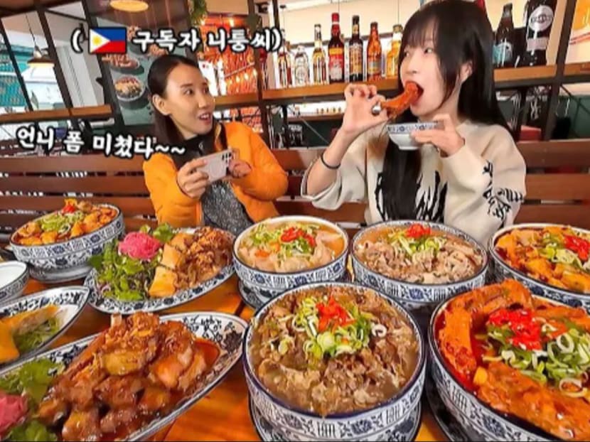 A mukbang video posted by popular Korean YouTuber Tzuyang (right) featured a "Filipino subscriber" who was later revealed to be Korean comedian Kim Ji Young (eft).