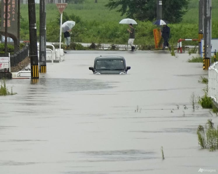 Heavy rain and flooding in north-central Japan strands people and vehicles