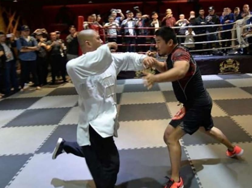 Mr Xu Xiaodong (right) in combat with tai chi master Wei Lei. Handout via SCMP
