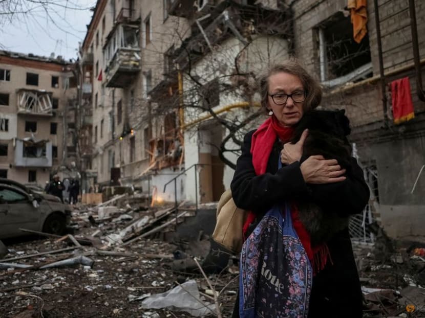 A local resident holding a cat leaves the site where residential buildings were heavily damaged during a Russian missile attack, amid Russia's attack on Ukraine, in central Kharkiv, Ukraine on Jan 2, 2024.