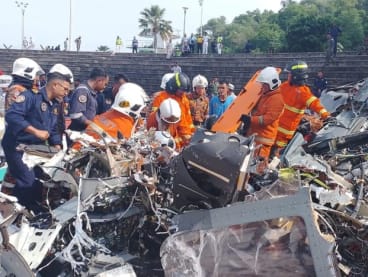 Rescuers inspecting the debris of the fatal Perak helicopter crash. 