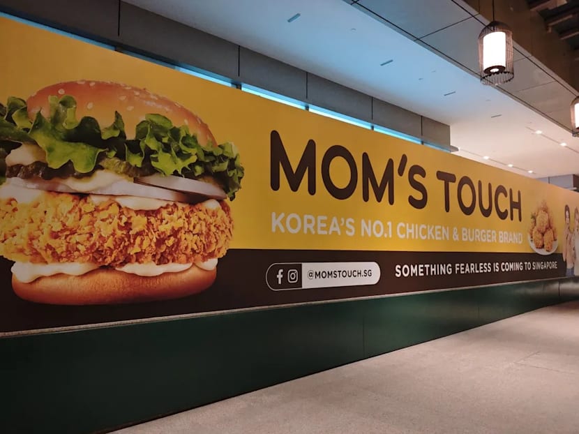 Korean fast food chain Mom's Touch returning to Singapore, banner with K-pop group Le Sserafim seen at Chinatown Korean fast food chain Mom's Touch returning to Singapore, banner with K-pop group Le Sserafim seen at Chinatown