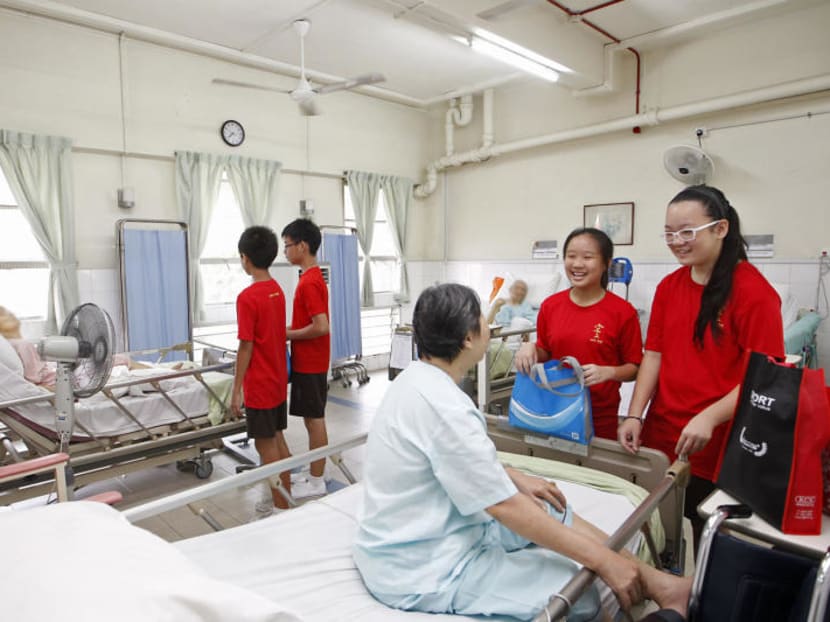 Children visiting patients at Kwong Wai Shiu Hospital as part of their school’s programme. A reader says that the low national volunteerism rate in Singapore is curious in a country where school-based community service is mandated.