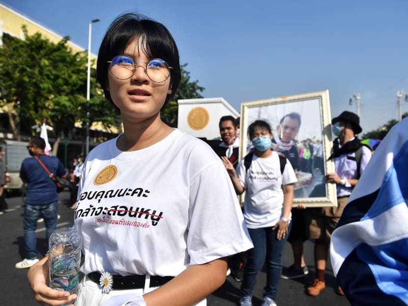 Teenage protest leader Benjamaporn "Ploy" Nivas takes part in a pro-democracy rally in Bangkok on Nov 14, 2020. In the eyes of Thailand's ultra-conservative school system with its strict dress codes and mandated long ponytails with ribbons for female students, Ploy has been cast as a rebel for daring to show a whiff of individuality.