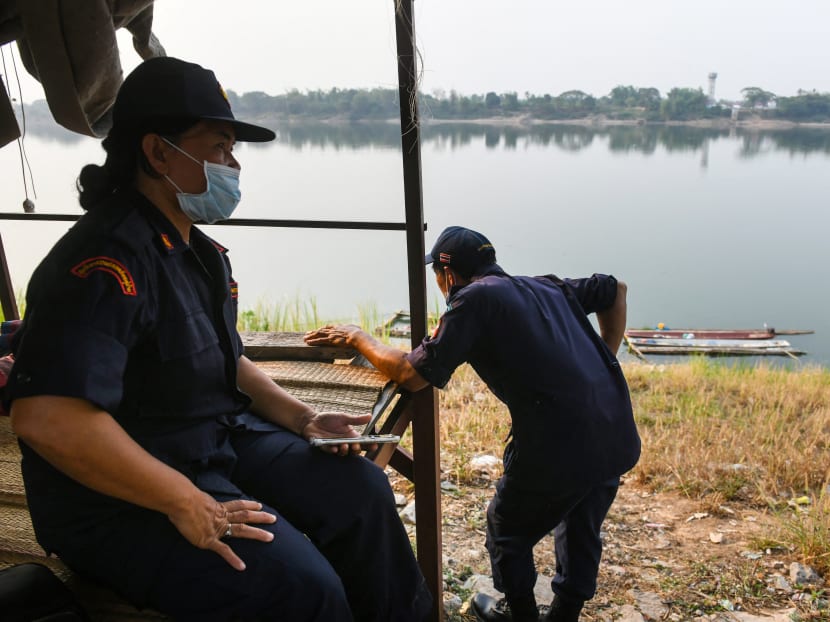 Members of a village security unit looking out over the Mekong river in the northern Thai region of Nong Khai, bordering Laos on March 15, 2021. Members of a village security unit looking out over the Mekong river in the northern Thai region of Nong Khai, bordering Laos on March 15, 2021.