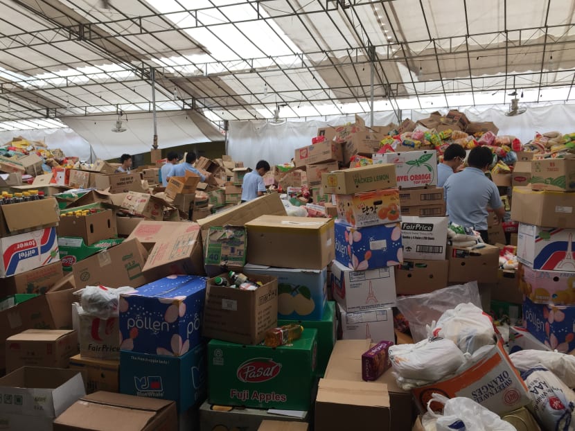 Boys' Brigade members packing donation items consisting of rice, soy sauce and biscuits, which will be delivered to 35,845 beneficiaries. Photo: Elgin Chong
