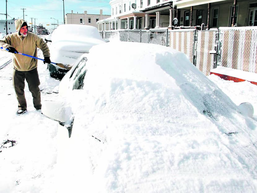 A man digging out his car in New Jersey, as record cold temperatures are set to hit the area in coming days. Photo: AP