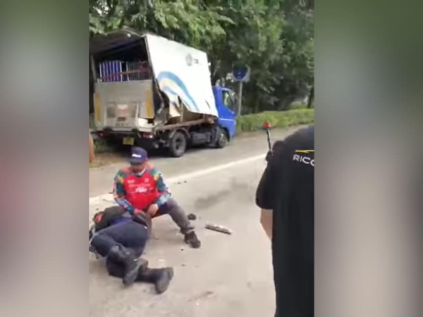 In a video that has been posted on the Roads.sg Facebook page, an officer from the Traffic Police clad in a black jacket can be seen lying on his side while another man attends to him. In a video that has been posted on the Roads.sg Facebook page, an officer from the Traffic Police clad in a black jacket can be seen lying on his side while another man attends to him.