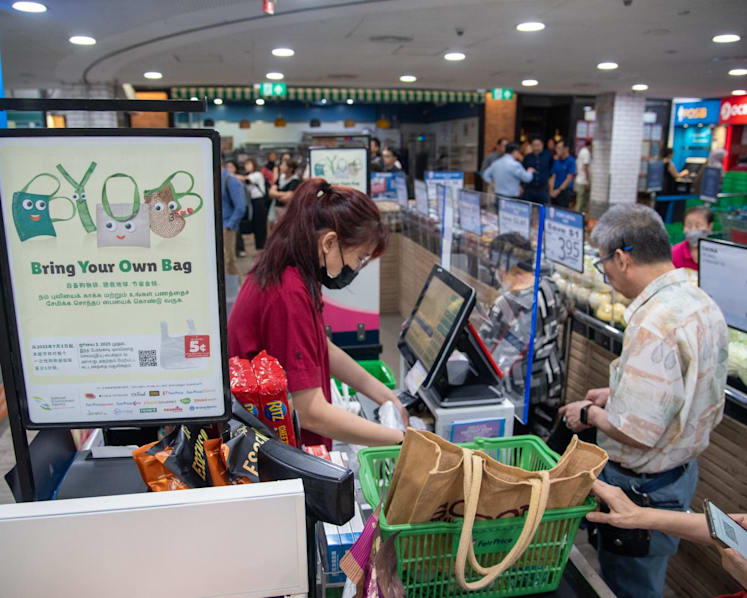 Shoppers still using plastic bags on day 1 of mandatory disposable bag charge cite convenience, habit