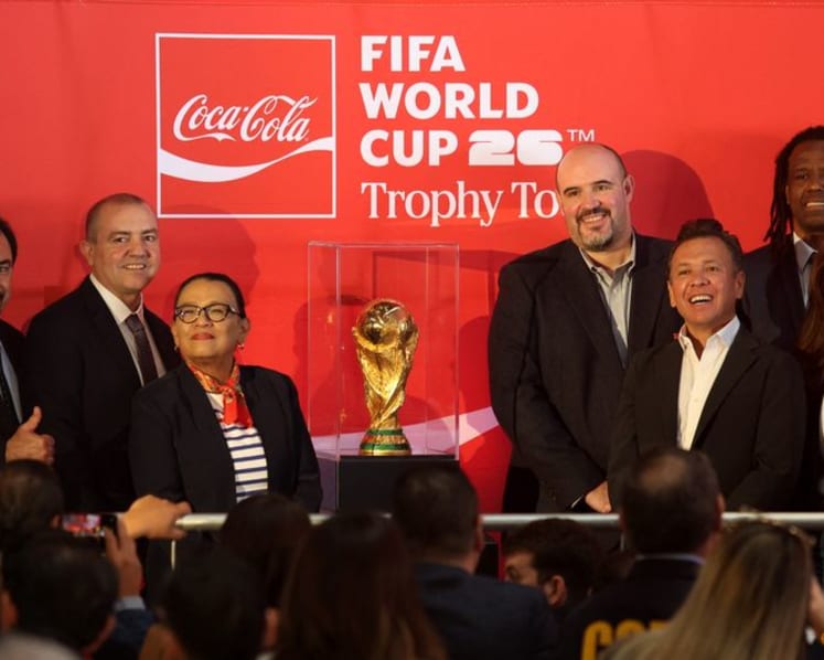 Mexican fans enjoy a brief respite from violence as they gaze at World Cup trophy