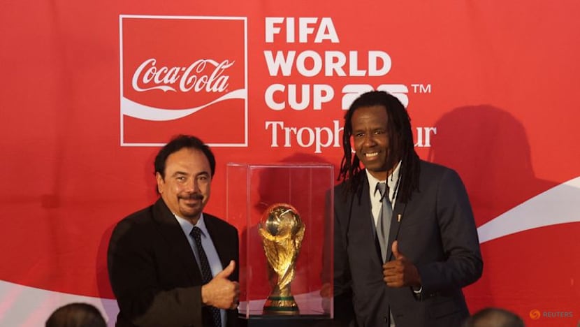 Mexican fans enjoy a brief respite from violence as they gaze at World Cup trophy
