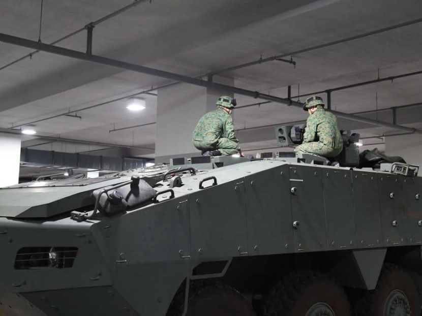 SAF personnel are seen conducting serviceability checks on an SAF Terrex ICV. Photo: Mindef