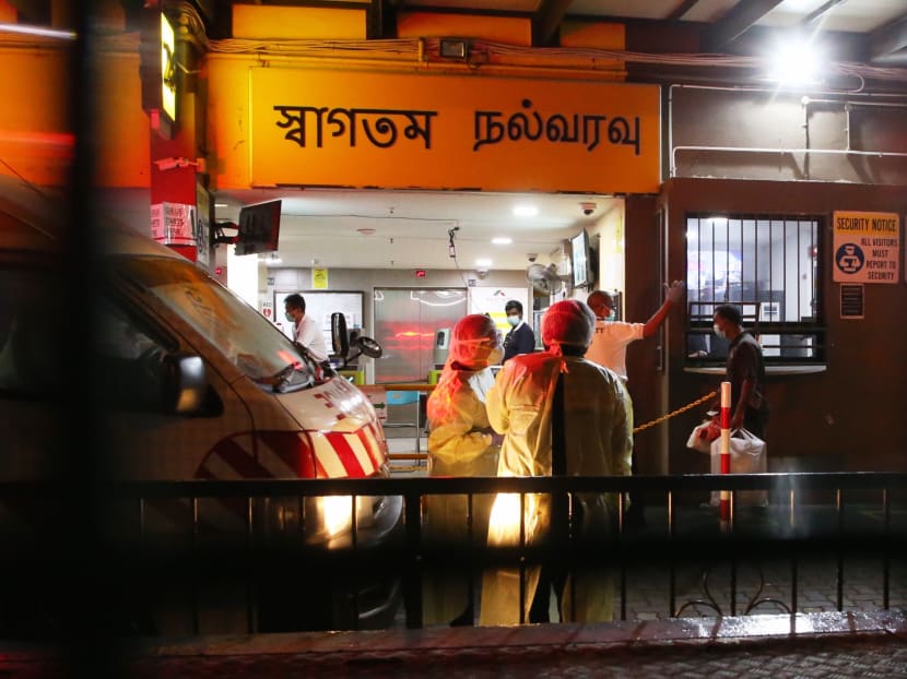 The police and medical personnel were seen at the entrance of Westlite Toh Guan dormitory at Block 28, Toh Guan Road East, as workers return for the day on Sunday, April 5, 2020. The police and medical personnel were seen at the entrance of Westlite Toh Guan dormitory at Block 28, Toh Guan Road East, as workers return for the day on Sunday, April 5, 2020.