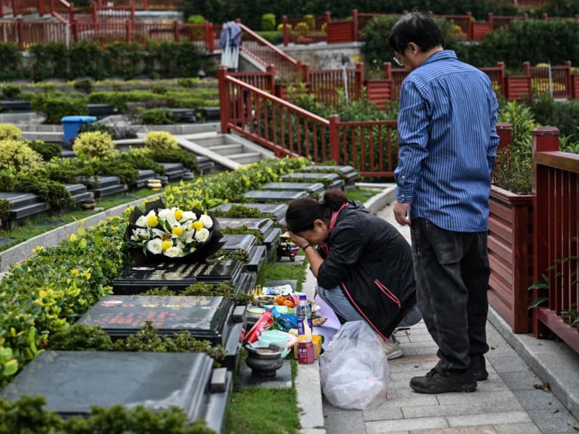 This photo taken on Nov 7, 2023 shows Mr Wu Seakoo and his wife visiting the grave of their son Wu Xuanmo, who died last year aged 22 while attending Exeter University in Britain, at a cemetery in China's eastern Zhejiang province.