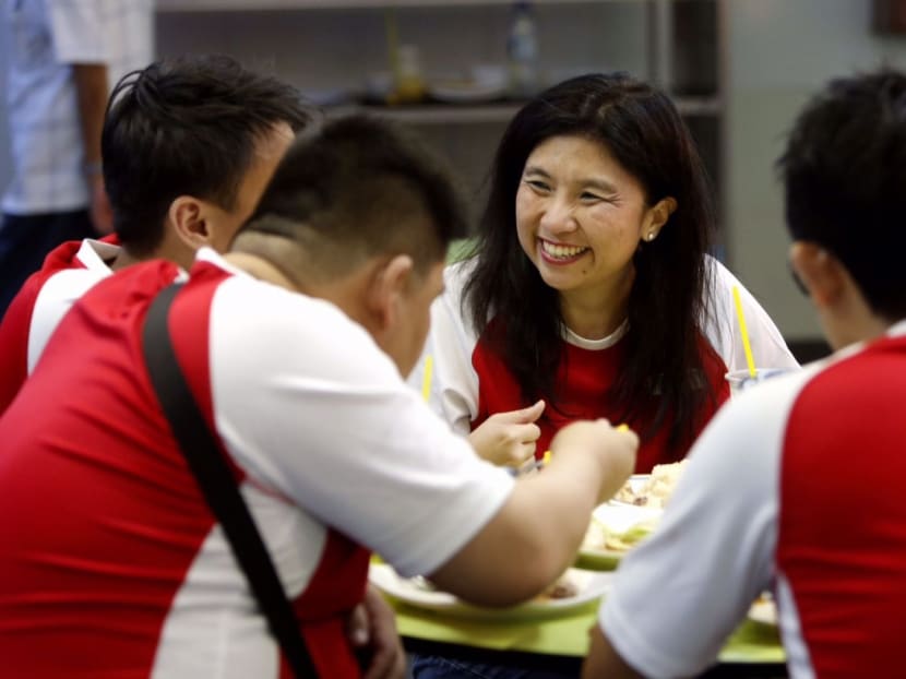 Jeannette Chong-Aruldoss taking a break with party volunteers before meeting residents at Kampung Arang. Photo: Raj Nadarajan