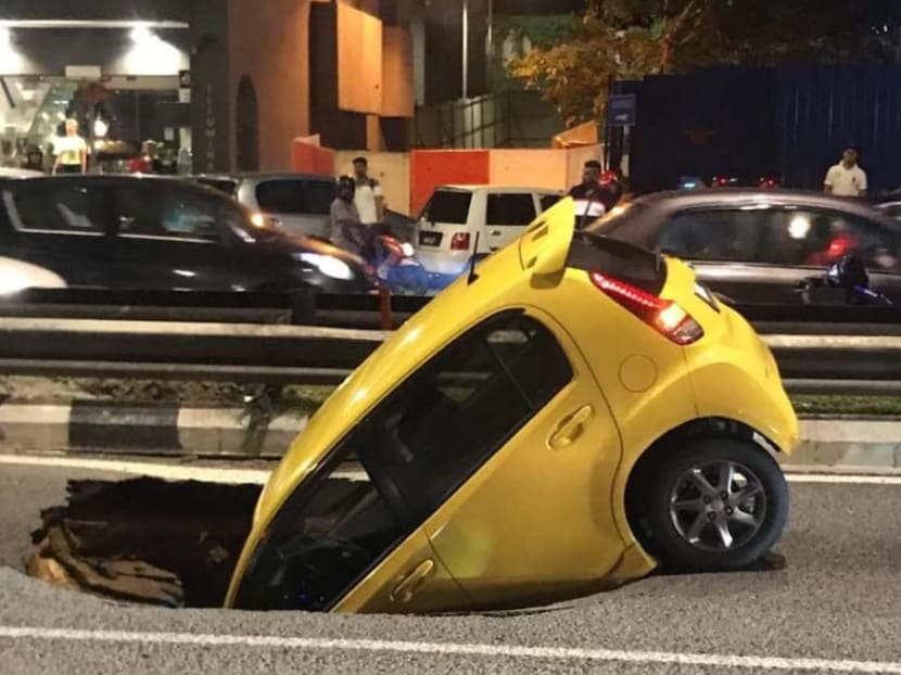 The car in the sinkhole at Jalan Maharajalela heading towards Jalan Loke Yew.