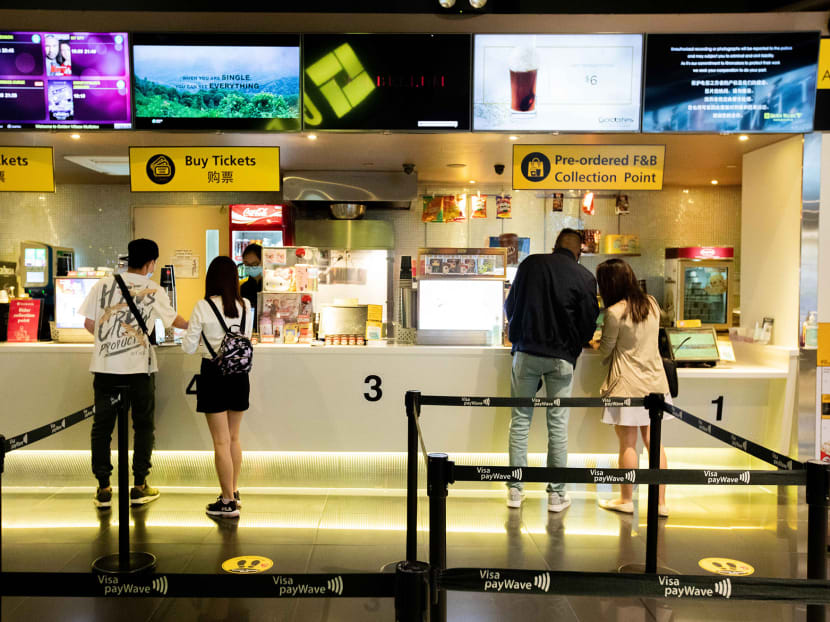 Moviegoers practice safe distancing while purchasing tickets at Golden Village cinema at Tampines Mall shopping centre on Monday, July 13, 2020. Moviegoers practice safe distancing while purchasing tickets at Golden Village cinema at Tampines Mall shopping centre on Monday, July 13, 2020.