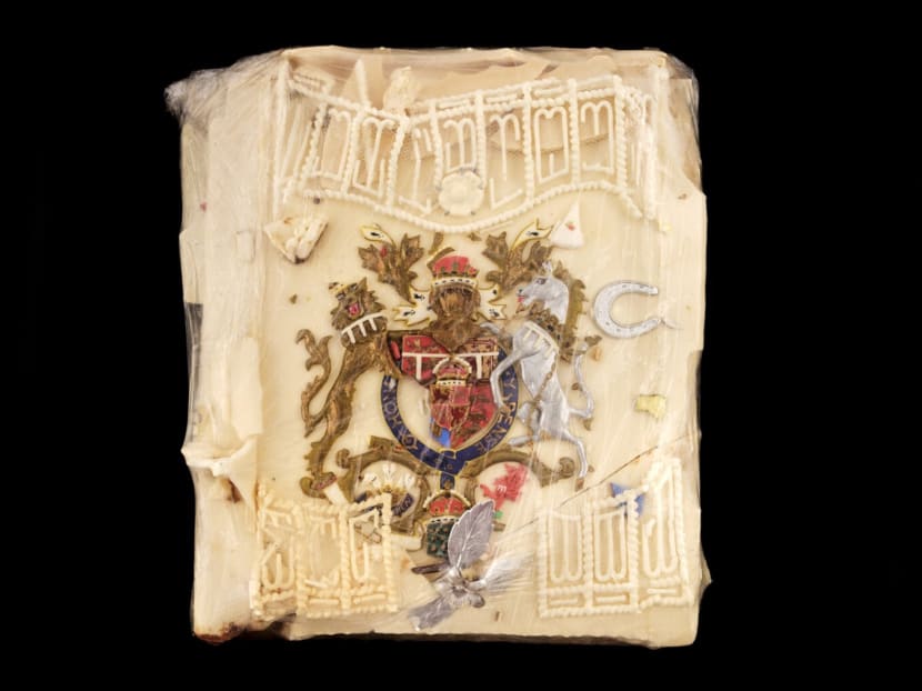 An undated handout picture released on Aug 11, 2021 shows a slice of cake from the 1981 wedding of Prince Charles and Diana that is up for auction today.