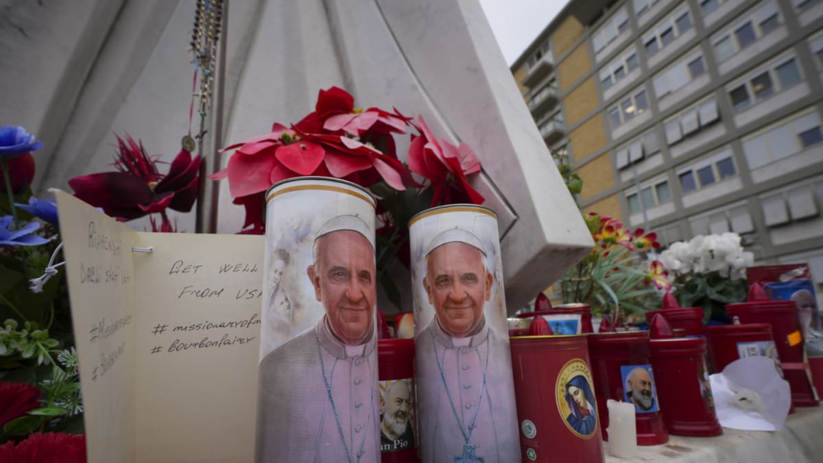 Pope Francis is alert in hospital, Vatican says, as people leave flowers and notes