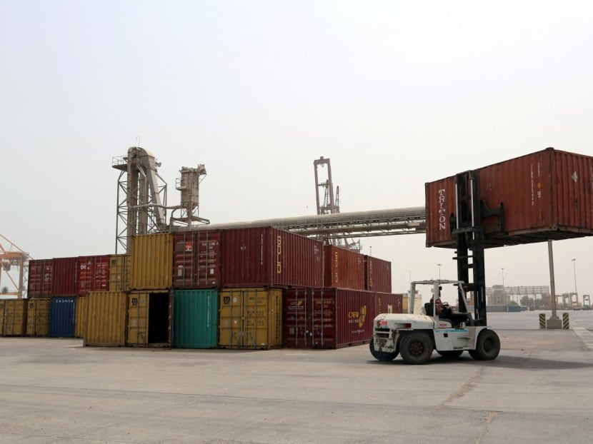 A forklift carries a shipping container at the Red Sea port of Hodeidah, Yemen June 24, 2018.