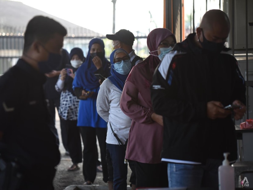 Johor state election: Voters cast their ballots on polling day amid tight COVID-19 protocols 