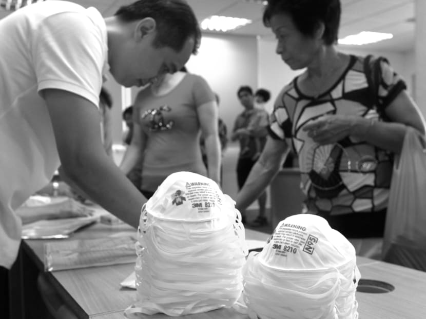Volunteers handing out haze masks to residents in Ang Mo Kio. It is crucial how we

nurture the sense of looking out for each other in times of crisis. TODAY file photo