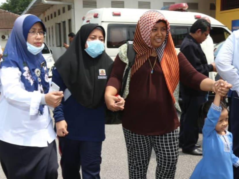 A mother accompanies her child from SK Taman Pasir Putih, who suffered from breathing difficulties.