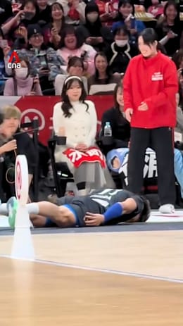 Japanese volleyball player slides across court to apologise after hitting woman with ball