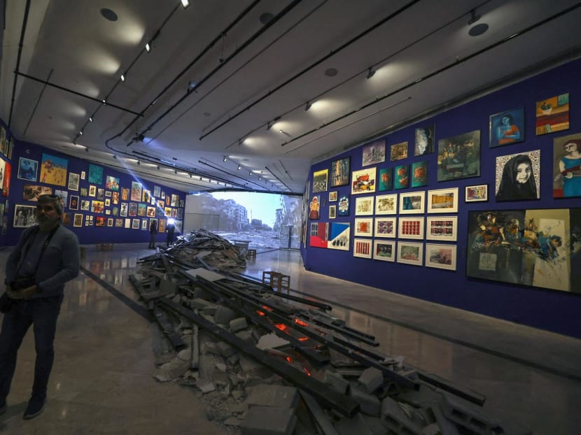 People visit the 'This Is Not An Exhibition' section displaying paintings by Gazan artists, as the Palestinian Museum reopened in the town of Birzeit in the occupied West Bank on Feb 11, 2024.