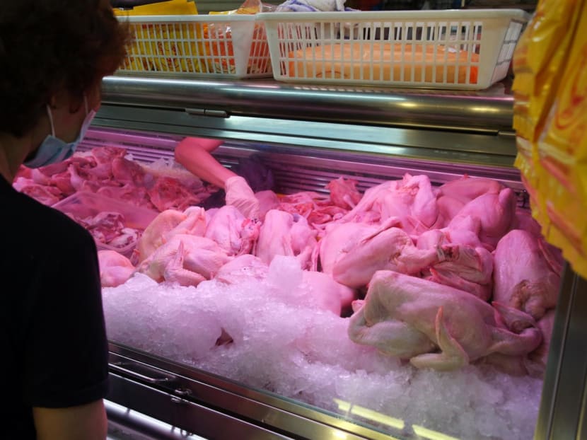 A customer buying chicken from a stall selling poultry at a wet market in Vista Point on May 25, 2022. A customer buying chicken from a stall selling poultry at a wet market in Vista Point on May 25, 2022.