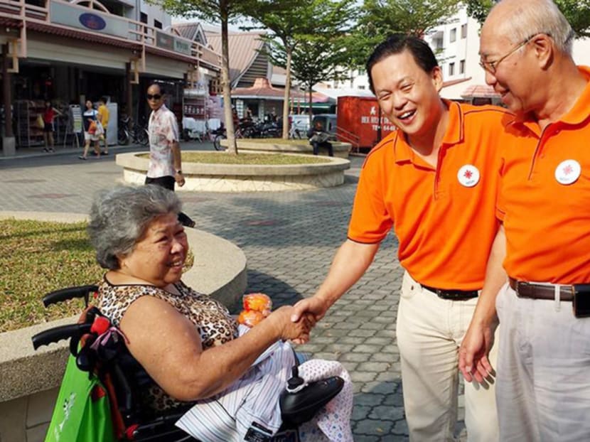 Former Secretary-General of NSP Tan Lam Siong (centre) with Council Member Kwan Yue Kang during the party's Chinese New Year outreach earlier this year. Photo: National Solidarity Party/Facebook
