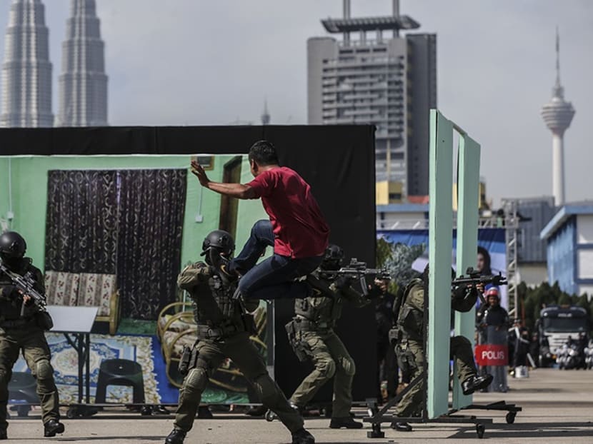 Members of the Malaysian Police take part in a demonstration showing a mock terrorist attack during the 211th National Day celebration at Pulapol in Kuala Lumpur earlier this year.