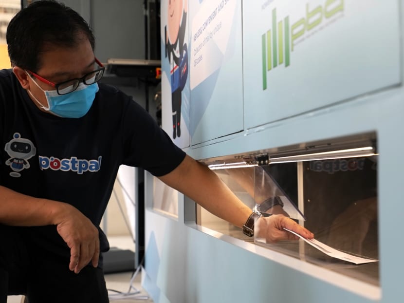 Retrieval of mail from PostPal, SingPost’s smart letterbox, at a public housing block on Sumang Lane at Punggol.
