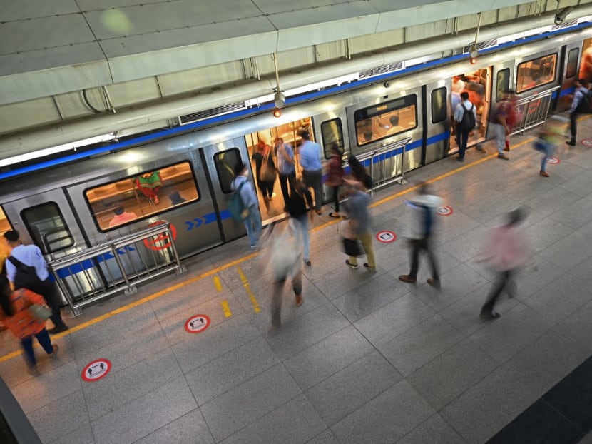 Commuters board the metro at a station after the services were allowed to operate at 50 per cent capacity in New Delhi on June 7, 2021, as India's capital began a gradual easing of restrictions after infections across the country fell to a two-month low.