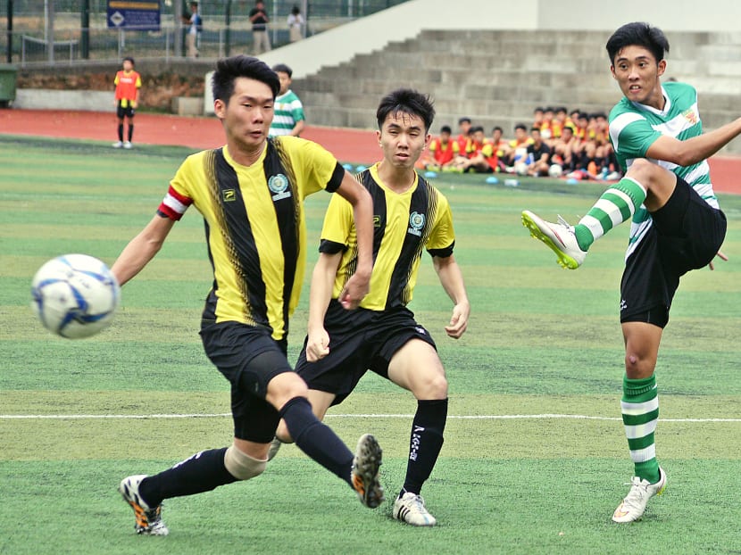 Teenager Jonathan Chua (right) was praised by Raffles Institution’s captain and head coach for the honesty and integrity he showed in the second round of the Schools National A Division Football Championships. Photo: Robin Choo/TODAY