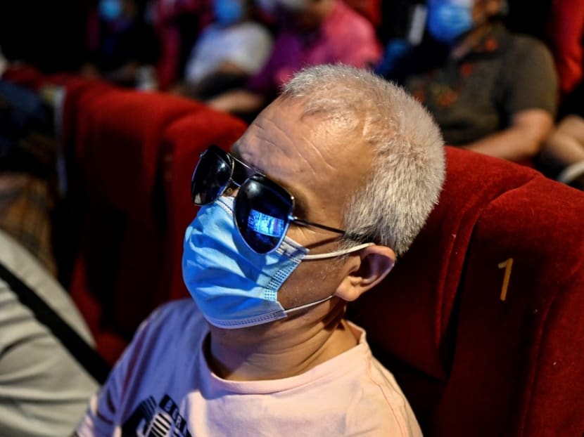 This photo taken on Aug 7, 2021 shows visually impaired massage therapist Zhang Xinsheng listening to the film narrator during a screening at a cinema in Beijing. This photo taken on Aug 7, 2021 shows visually impaired massage therapist Zhang Xinsheng listening to the film narrator during a screening at a cinema in Beijing.