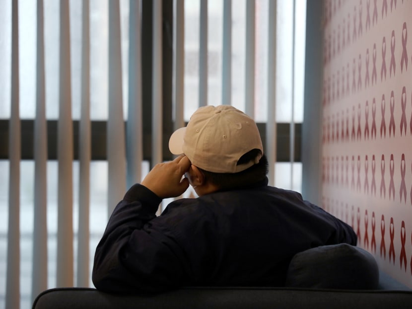 A back view of a 50-year-old heterosexual Singaporean who has HIV. The Covid-19 crisis has wiped out his business and affected his medical treatments.