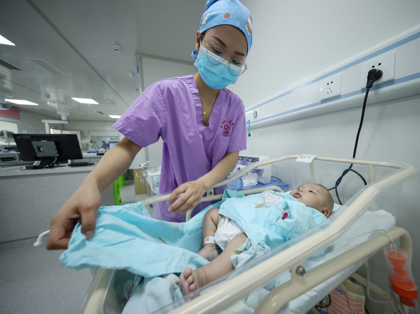 A medical staff member taking care of a newborn baby at a hospital in Danzhai, in China's southwestern Guizhou province, on May 11, 2021. A medical staff member taking care of a newborn baby at a hospital in Danzhai, in China's southwestern Guizhou province, on May 11, 2021.