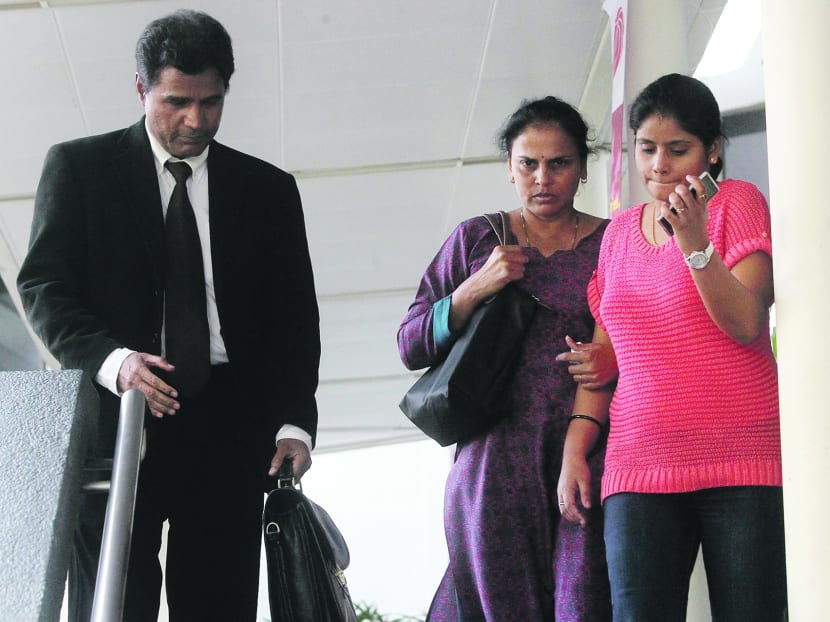 The mother (in purple) of the deceased prison inmate, Dinesh Raman Chinnaiah, at the Subordinate Courts on July 19, 2013. Photo: Ooi Boon Keong