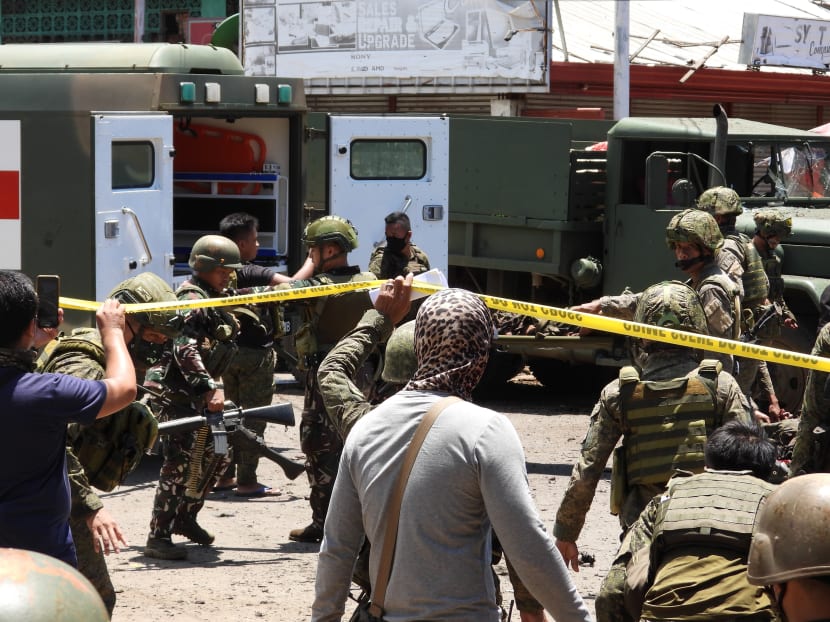 Military personnel stretcher away some of the victims after an improvised bomb exploded next to a military vehicle in the town of Jolo, Sulu province on the southern island of Mindanao on Monday, Aug 24, 2020.