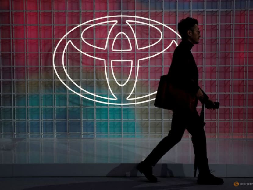 FILE PHOTO: A man walks past a Toyota logo at the Tokyo Motor Show, in Tokyo, Japan October 24, 2019. REUTERS/Edgar Su/File Photo FILE PHOTO: A man walks past a Toyota logo at the Tokyo Motor Show, in Tokyo, Japan October 24, 2019. REUTERS/Edgar Su/File Photo