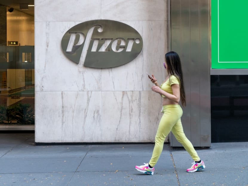 A woman walks by the Pfizer headquarters in New York City. The pharmaceutical firm announced positive early results on its Covid-19 vaccine trial.